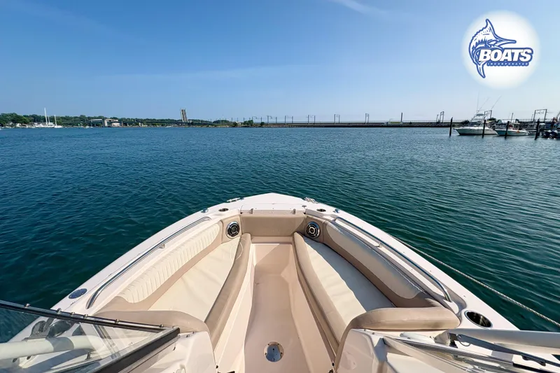 Slide: The Image of 2014 Grady-White Freedom 255 boat on calm water, clear sky, marina view. - 6