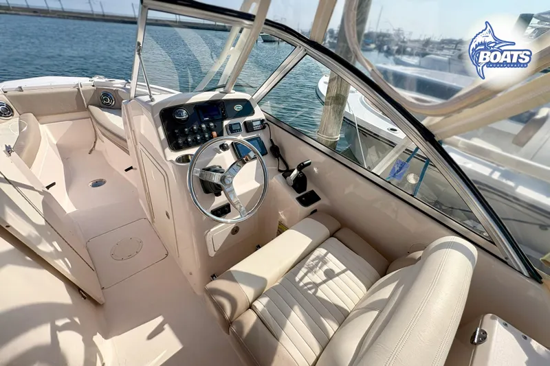 Slide: The Image of 2014 Grady-White Freedom 255 boat interior with steering wheel and seating. - 7
