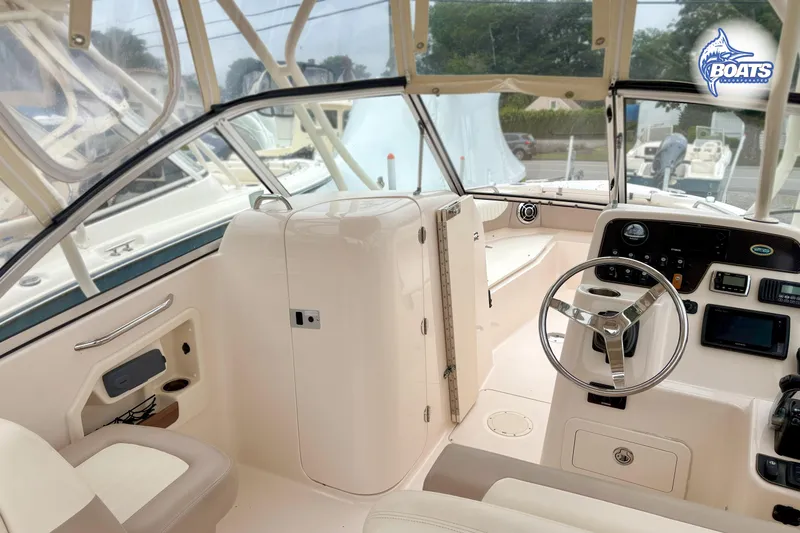 Slide: The Image of Interior view of a Grady-White Freedom 255 boat with helm and seating. - 8