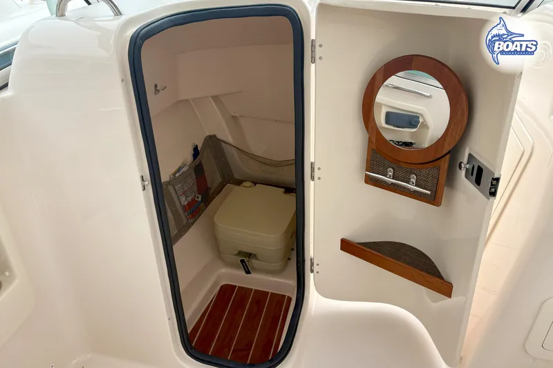 Slide: The Image of Interior of a Grady-White Freedom 255 with a toilet and mirror. - 9