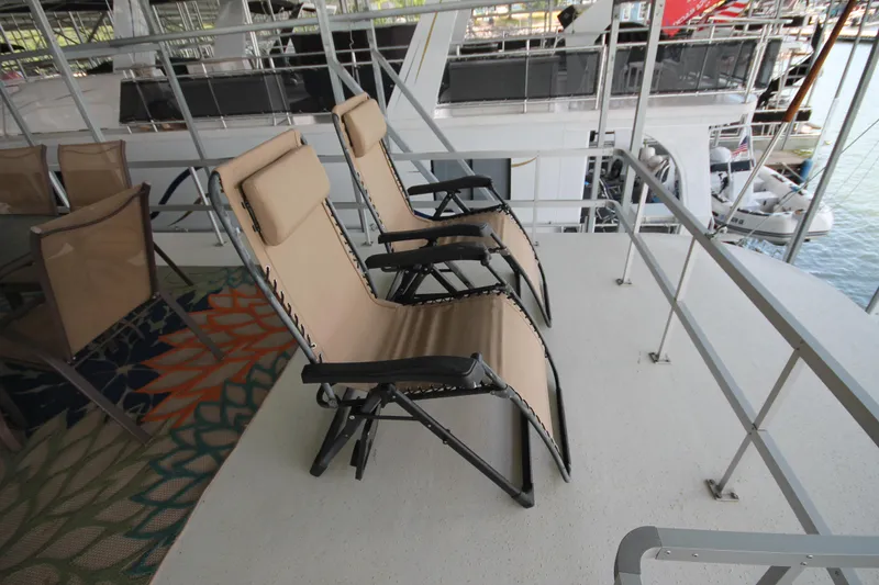 Slide: The Image of Deck chairs on a 2011 Gibson 50 Cabin Yacht, overlooking marina. - 13