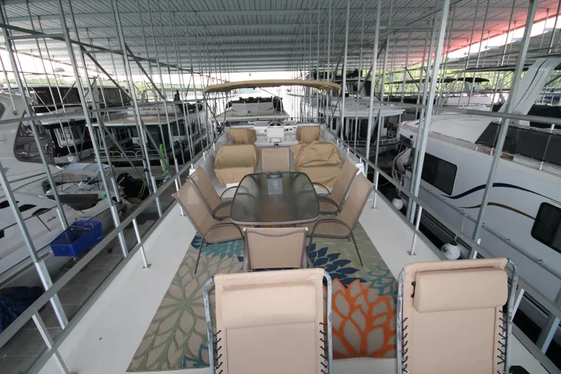 Slide: The Image of 2011 Gibson 50 Cabin Yacht with outdoor seating under covered dock. - 14