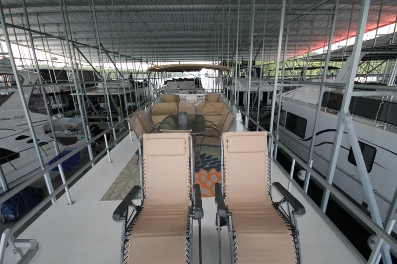 Slide: The Image of 2011 Gibson 50 Cabin Yacht with outdoor seating under covered marina. - 16