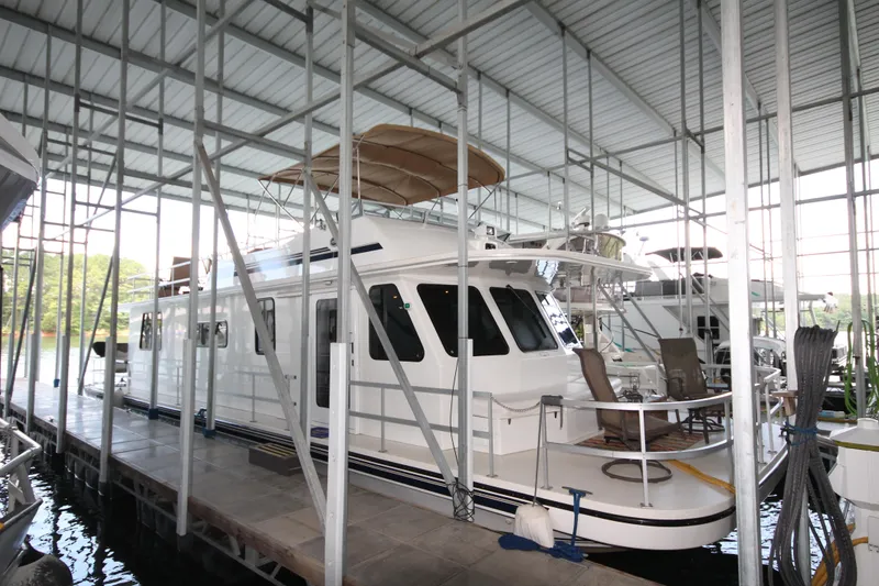 Slide: The Image of 2011 Gibson 50 Cabin Yacht docked in a covered marina. - 2