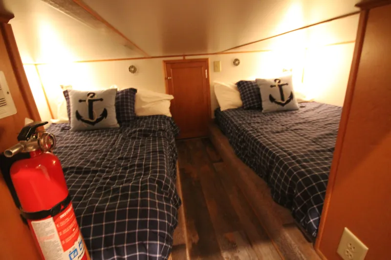 Slide: The Image of Cozy cabin bedroom in 2011 Gibson 50 Yacht with nautical-themed decor and twin beds. - 25