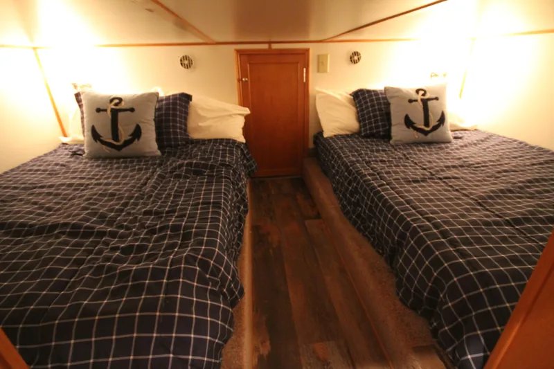 Slide: The Image of Cozy cabin bedroom in 2011 Gibson 50 Yacht with nautical-themed bedding. - 26