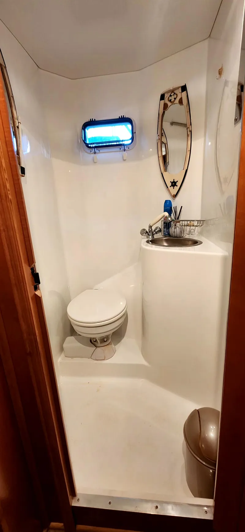Slide: The Image of Bathroom interior of 2011 Gibson 50 Cabin Yacht with toilet, sink, and porthole window. - 29
