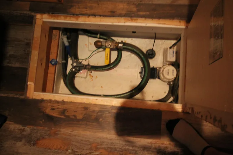Slide: The Image of Access panel of 2011 Gibson 50 Cabin Yacht showing plumbing and wiring components. - 34