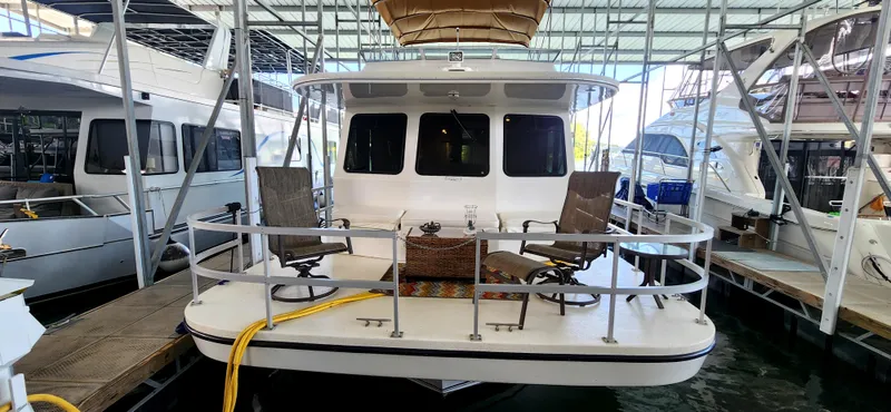 Slide: The Image of 2011 Gibson 50 Cabin Yacht docked with outdoor seating area. - 4