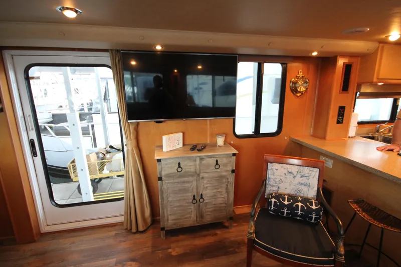 Slide: The Image of Interior of 2011 Gibson 50 Cabin Yacht with TV, chair, and nautical decor. - 42