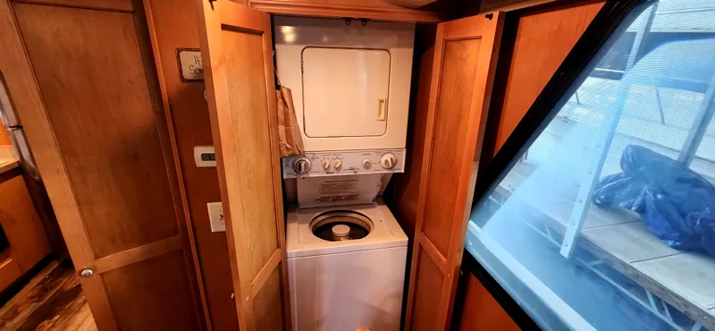 Slide: The Image of Laundry area with stacked washer-dryer in 2011 Gibson 50 Cabin Yacht. - 46