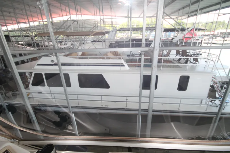 Slide: The Image of 2011 Gibson 50 Cabin Yacht docked in a marina, viewed through glass. - 5