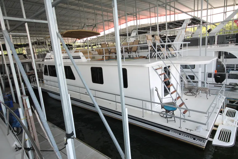 Slide: The Image of 2011 Gibson 50 Cabin Yacht docked in a covered marina. - 6