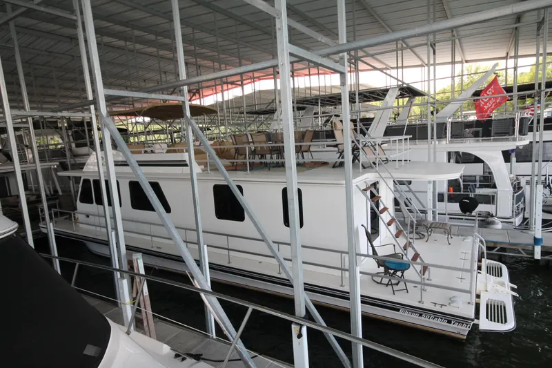 Slide: The Image of 2011 Gibson 50 Cabin Yacht docked in a covered marina. - 7
