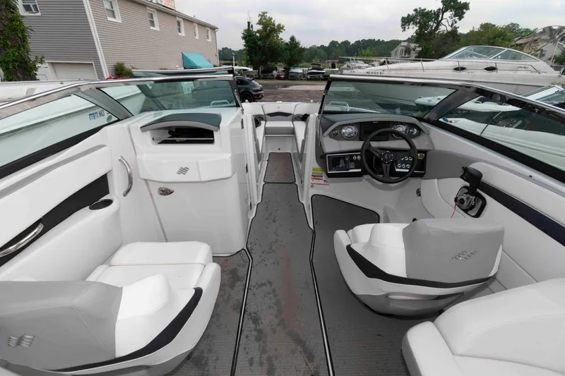 Slide: The Image of 2017 Four Winns H260 boat interior with white seating and modern dashboard. - 10