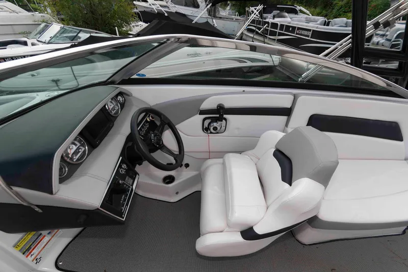 Slide: The Image of 2017 Four Winns H260 boat interior with steering wheel and seating. - 11