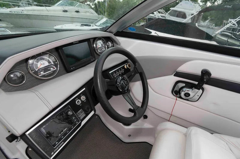 Slide: The Image of 2017 Four Winns H260 boat dashboard with steering wheel and control panel. - 13