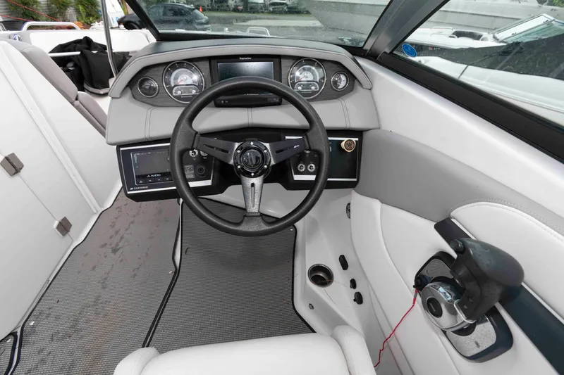 Slide: The Image of 2017 Four Winns H260 boat dashboard with steering wheel and control panel. - 14