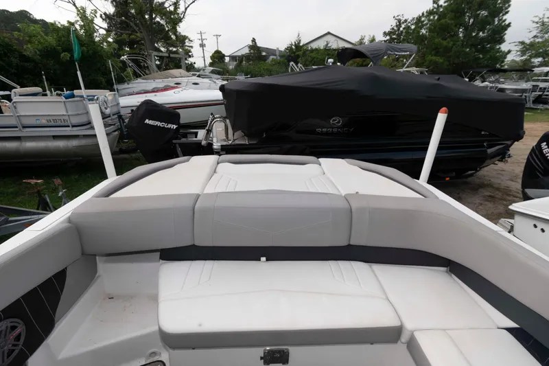 Slide: The Image of 2017 Four Winns H260 boat interior with cushioned seating, parked near other boats. - 15