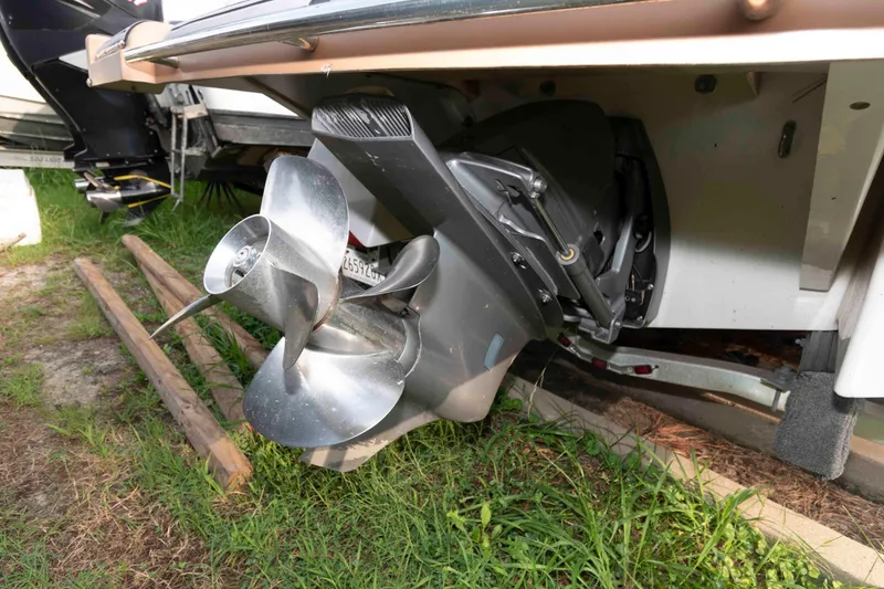 Slide: The Image of 2017 Four Winns H260 boat propeller and stern drive on grass. - 20