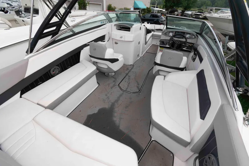 Slide: The Image of 2017 Four Winns H260 boat interior with white seating and modern dashboard. - 9