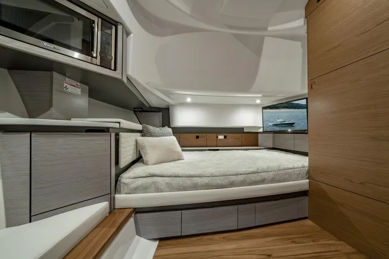 Slide: The Image of Luxurious interior of 2024 Tiara Yachts 43 LS, featuring a cozy bed and modern amenities. - 19