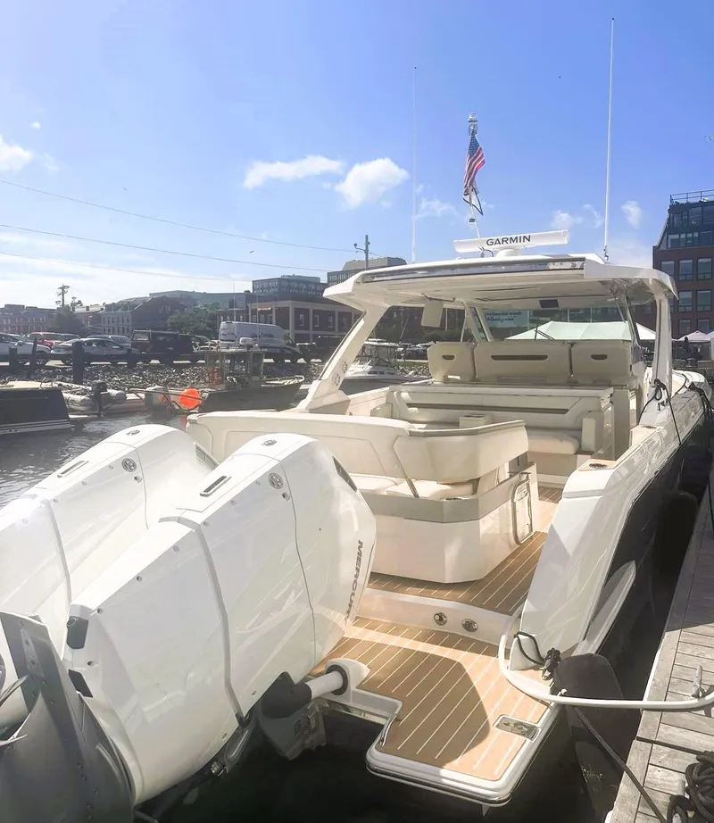 Slide: The Image of 2024 Tiara Yachts 43 LS luxury boat docked, featuring spacious seating and powerful engines. - 5