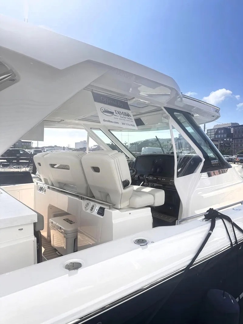 Slide: The Image of 2024 Tiara Yachts 43 LS interior with luxurious seating and modern dashboard. - 9