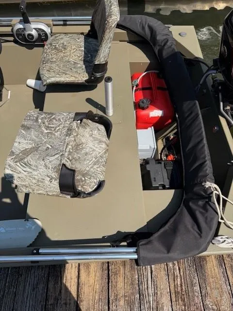 Slide: The Image of 2024 Tracker Grizzly 1648 SC boat interior with camo seats and equipment. - 3