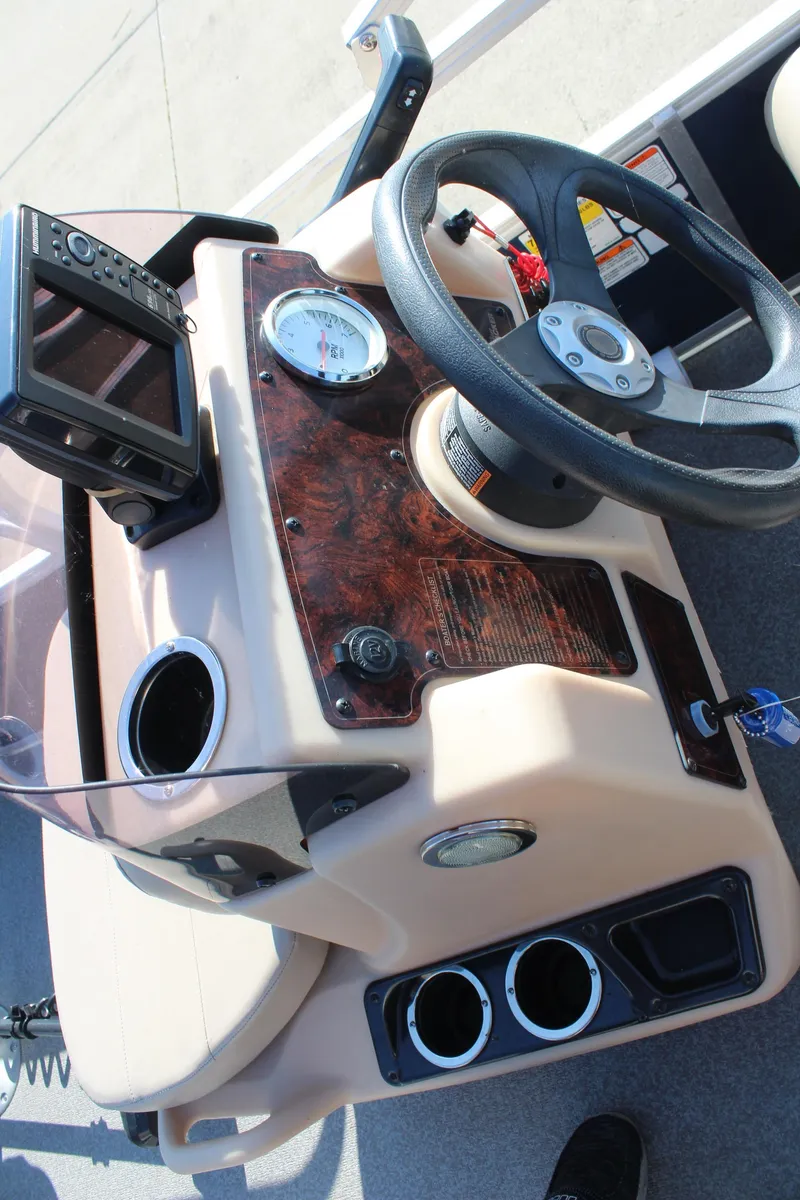 Slide: The Image of 2019 Sun Tracker Bass Buggy 16 XL Select dashboard with steering wheel and controls. - 15