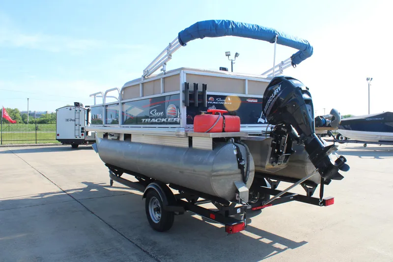 Slide: The Image of 2019 Sun Tracker Bass Buggy 16 XL Select pontoon boat on trailer, outdoor setting. - 5