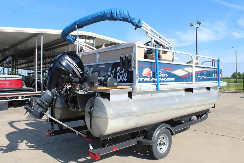 Slide: The Image of 2019 Sun Tracker Bass Buggy 16 XL Select pontoon boat on trailer, with Mercury outboard motor. - 7