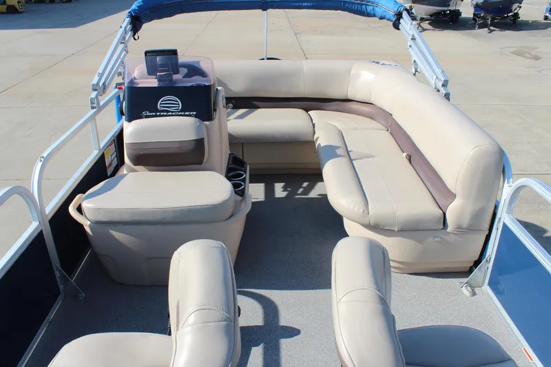 Slide: The Image of 2019 Sun Tracker Bass Buggy 16 XL Select pontoon boat interior with beige seating. - 9
