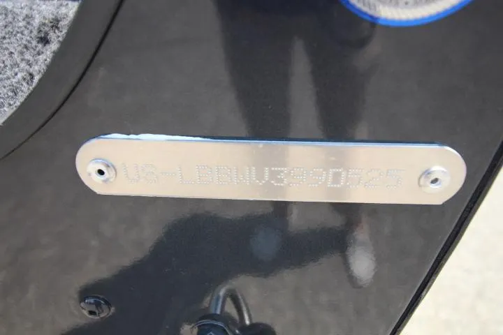 Slide: The Image of 2025 Lund 1875 Crossover XS boat identification plate on black surface. - 10