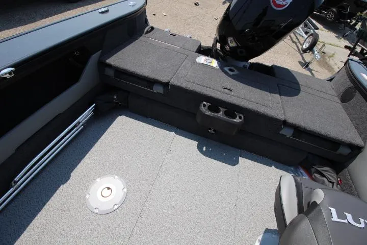 Slide: The Image of 2025 Lund 1875 Crossover XS boat interior with seating and motor, showcasing spacious design. - 5