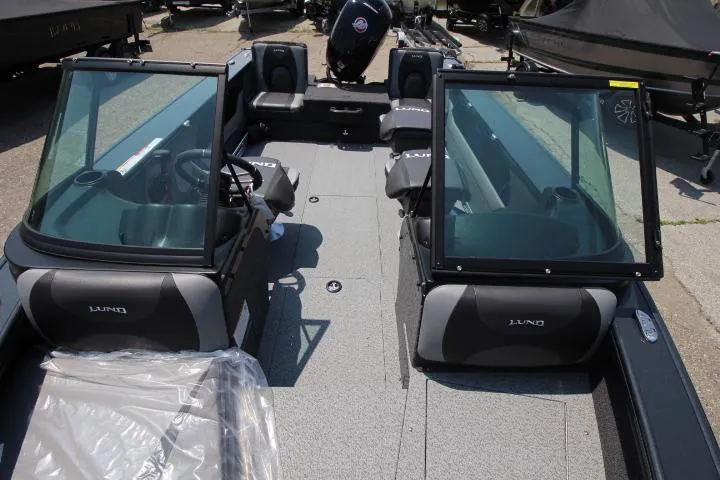 Slide: The Image of 2025 Lund 1875 Crossover XS boat interior with seating and windshield. - 9