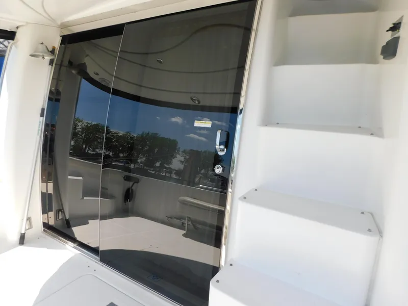 Slide: The Image of 2002 Carver 450 Voyager Pilothouse yacht with glass doors and white steps. - 12