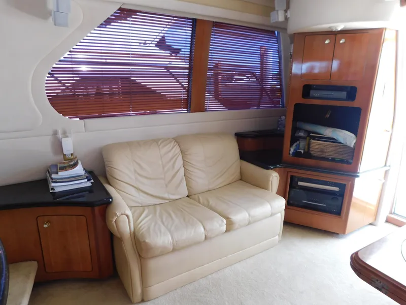 Slide: The Image of Interior of 2002 Carver 450 Voyager Pilothouse with beige sofa and wooden cabinetry. - 14