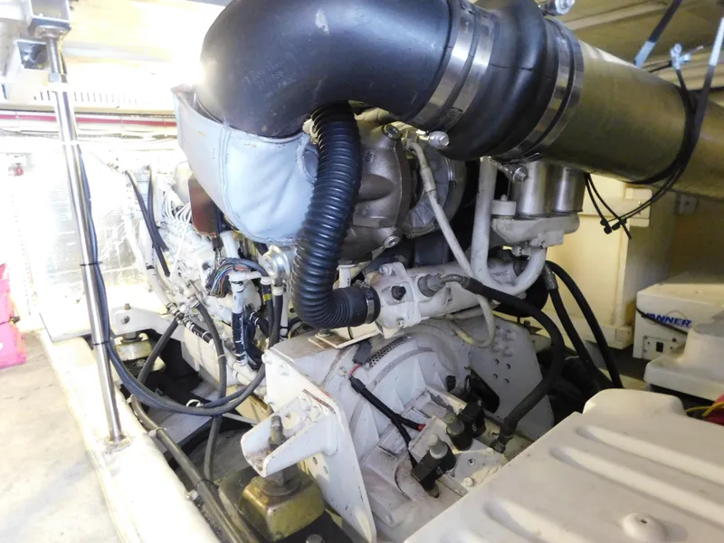 Slide: The Image of Engine room of 2002 Carver 450 Voyager Pilothouse, showcasing mechanical components and wiring. - 38