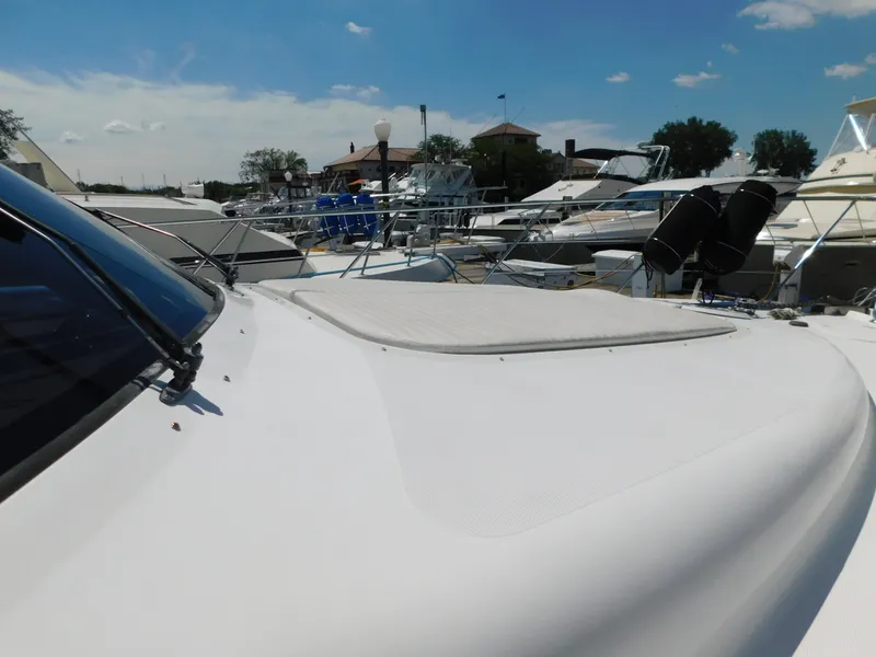 Slide: The Image of 2002 Carver 450 Voyager Pilothouse yacht docked at marina under clear blue sky. - 6