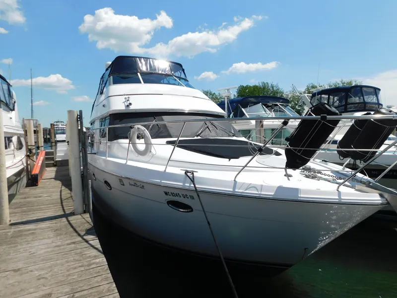 Slide: The Image of 2002 Carver 450 Voyager Pilothouse yacht docked at marina under blue sky. - 9