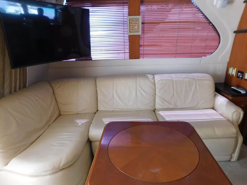 Slide: The Image of Luxurious interior of 2002 Carver 450 Voyager Pilothouse with leather seating and wooden table. - 16