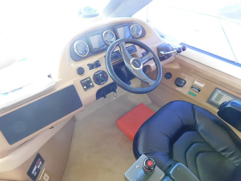 Slide: The Image of Pilothouse interior of 2002 Carver 450 Voyager, featuring steering wheel and control panel. - 19
