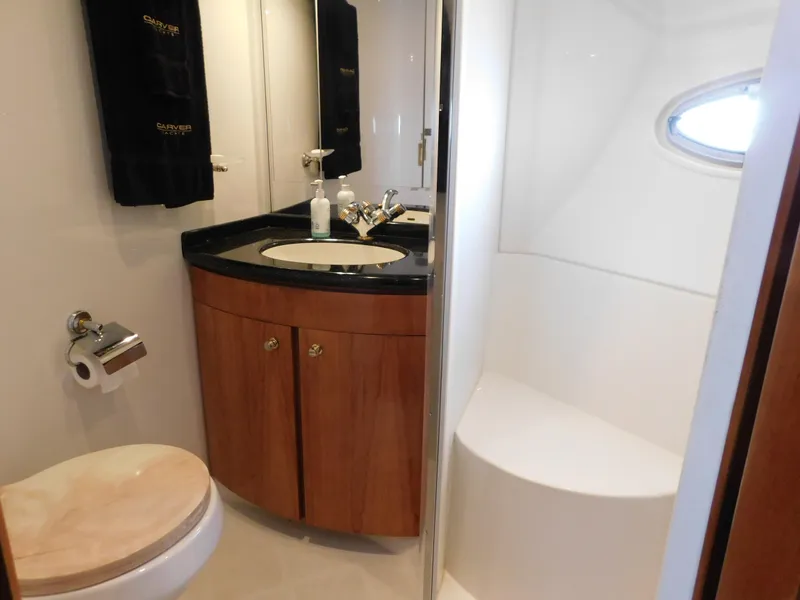 Slide: The Image of Bathroom interior of 2002 Carver 450 Voyager Pilothouse with sink, toilet, and shower. - 27