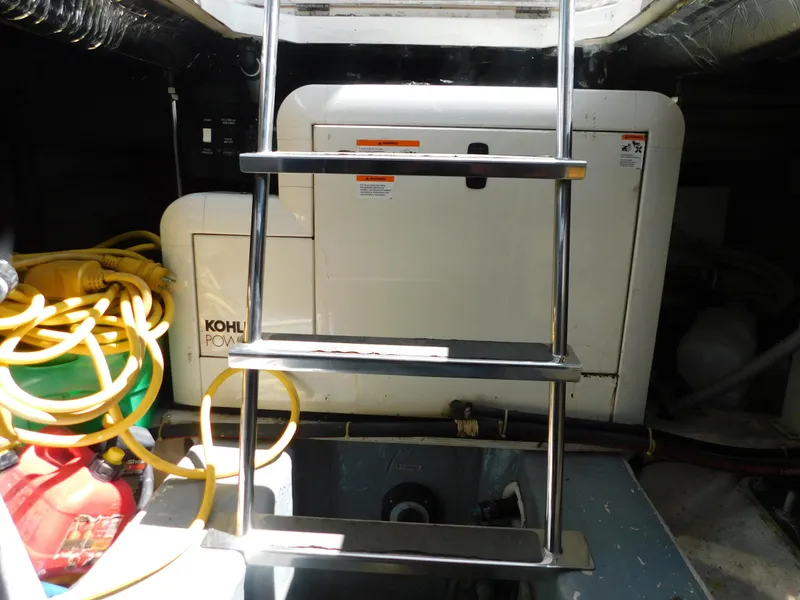 Slide: The Image of Engine room of 2002 Carver 450 Voyager Pilothouse with Kohler generator and ladder. - 40