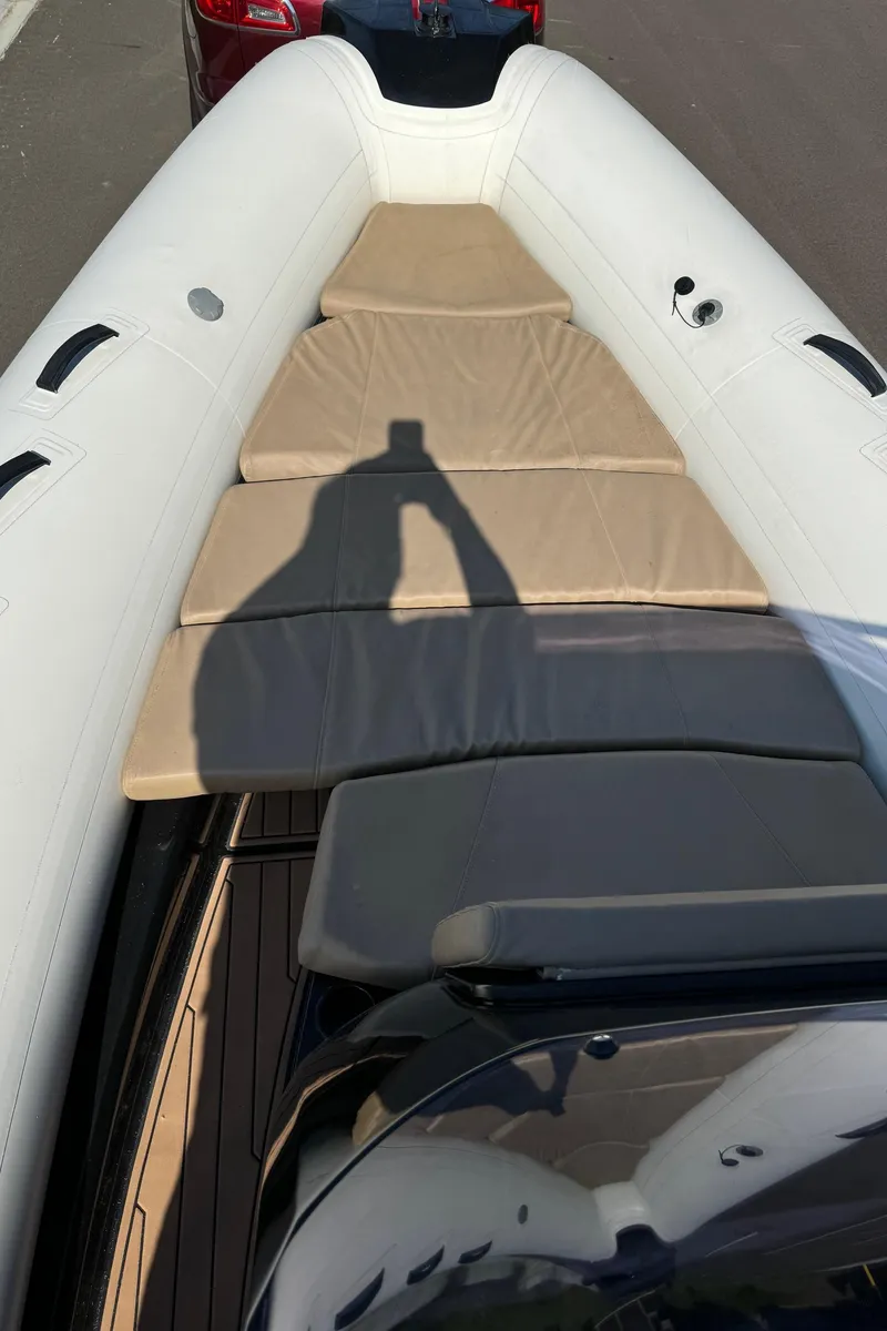 Slide: The Image of 2019 Brig Eagle 650 boat with beige seating and white inflatable sides. - 14