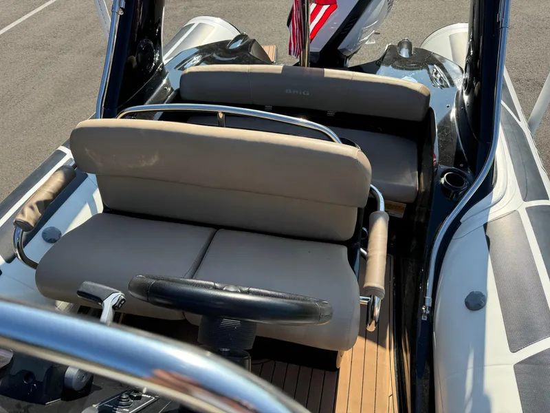 Slide: The Image of 2019 Brig Eagle 650 boat interior with beige seating and steering wheel. - 20