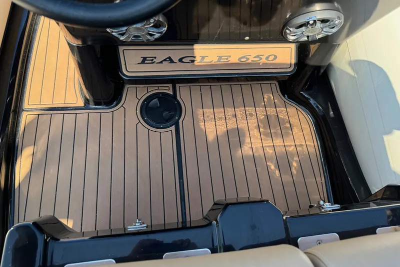 Slide: The Image of 2019 Brig Eagle 650 boat interior with teak flooring and steering wheel. - 21