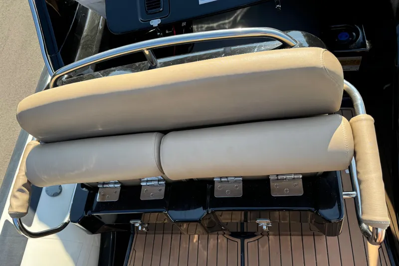 Slide: The Image of 2019 Brig Eagle 650 boat seat with beige cushions and stainless steel rail. - 22