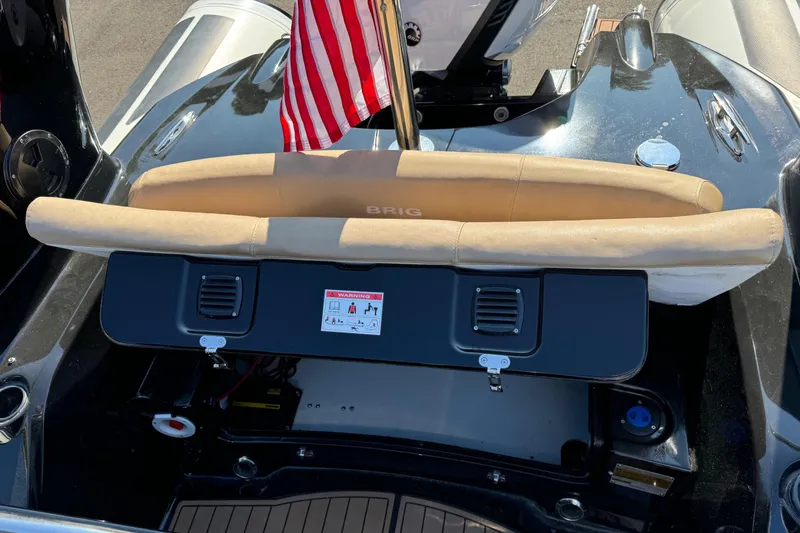 Slide: The Image of 2019 Brig Eagle 650 boat with American flag, rear seating view. - 25